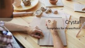  Presentation with handicraft embroidery design - PPT theme with table with pencil and sketchbook background and a coral colored foreground