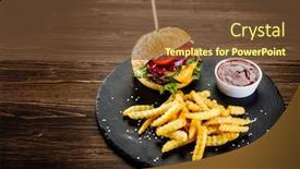  Presentation with burger - PPT layouts having tasty burger with chips served on black stone on wooden background background and a tawny brown colored foreground