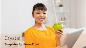  Presentation with green technology - PPT theme enhanced with technology education diet and people concept - happy young asian woman sitting on sofa with tablet pc computer and green apple at home background and a gold colored foreground