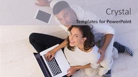  Presentation with computers - PPT layouts consisting of top view of a young couple relaxing at home with tablet and laptop computers reading on the floor background and a light gray colored foreground