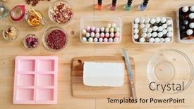 Presentation with molds - Audience pleasing presentation theme consisting of top view of large bar of white hard soap mass on wooden board bottles with various scents and essential oils and silicone molds backdrop and a lemonade colored foreground