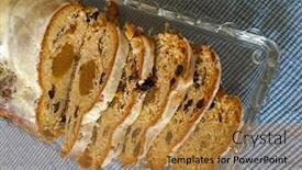  Presentation with tablecloth - PPT theme enhanced with top view of slices of homemade christmas stollen cake with raisins nuts spices and chopped dried fruit on blue tablecloth background and a gold colored foreground