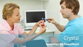  Presentation with artificial teeth - Slide set consisting of two dentists show how to correctly brush teeth for clarity doctors use an artificial jaw focus on woman background and a teal colored foreground