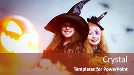  Presentation with witches - Theme featuring two girls dressed in witches one holding a book and the other with a halloween pumpkin looking at camera and smiling behind the flashing jack o lantern background and a tawny brown colored foreground
