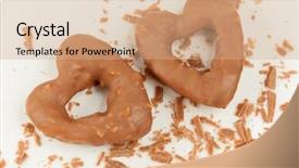  Presentation with chocolate nuts - Presentation consisting of two heart-shaped cookies with glaze of chocolate and nuts and crumbs of glaze on plate background and a coral colored foreground