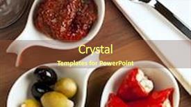  Presentation with peppers - Theme with variety of antipasti with marinated dried tomatoes black and green olives stuffed red peppers background and a tawny brown colored foreground