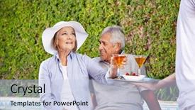  Presentation with waiter - Amazing theme having waiter serving cocktails to two senior people at the hotel pool backdrop and a light blue colored foreground