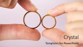  Presentation with wedding rings - Cool new theme with woman and man holding wedding rings close-up on bright background backdrop and a coral colored foreground