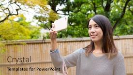  Presentation with old photo - Cool new PPT theme with woman taking photo by cellphone at japanese old town backdrop and a coral colored foreground
