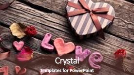  Presentation with gift ribbon - Colorful PPT theme enhanced with word love with heart shaped valentines day gift box on old vintage wooden plates sweet holiday background with rose petals small hearts curved ribbon backdrop and a tawny brown colored foreground