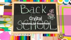  Presentation with school desk - PPT theme featuring words 'back to school' written in chalk on the small school desk with various school supplies close-up background and a dark gray colored foreground