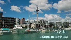  Presentation with luxury yacht - PPT theme with yacht at auckland harbor with luxury apartment background background and a ocean colored foreground
