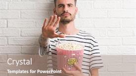  Presentation with white brick - Theme featuring young adult man eating popcorn standing over white brick wall with open hand doing stop sign with serious and confident expression defense gesture background and a coral colored foreground