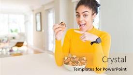  Presentation with muffins - Slide set having young african american woman eating chocolate chips muffins very happy pointing with hand and finger background and a yellow colored foreground