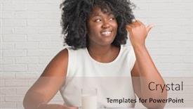  Presentation with drinking glass - Presentation theme having young african american woman sitting on the table drinking a glass of milk pointing and showing with thumb up to the side with happy face smiling background and a coral colored foreground