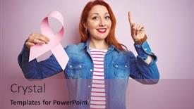  Presentation with cancer - Theme having young beautiful redhead woman holding cancer ribbon over pink isolated background surprised with an idea or question pointing finger with happy face number one background and a coral colored foreground