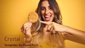  Presentation with biscuit - PPT theme featuring young beautiful woman eating biscuit over grey isolated background very happy pointing with hand and finger background and a gold colored foreground