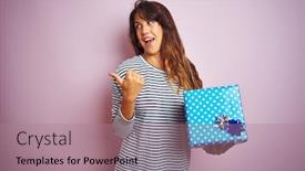  Presentation with pink birthday - Slide set enhanced with young beautiful woman holding birthday gift over pink isolated background pointing and showing with thumb up to the side with happy face smiling background and a coral colored foreground