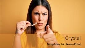  Presentation with orthodontic - Audience pleasing theme consisting of young-beautiful-woman-holding-dental backdrop and a gold colored foreground