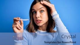  Presentation with orthodontic - Amazing PPT theme having young-blonde-girl-holding-dental backdrop and a light blue colored foreground