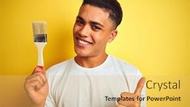  Presentation with brush - Cool new theme with young brazilian painter man holding brush standing over isolated yellow background happy with big smile doing ok sign thumb up with fingers excellent sign backdrop and a yellow colored foreground