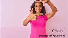  Presentation with frame pink - Presentation enhanced with young brazilian woman wearing t-shirt standing over isolated pink background smiling making frame with hands and fingers with happy face creativity and photography concept background and a coral colored foreground