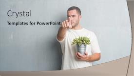  Presentation with hand holding plant - Audience pleasing presentation theme consisting of young caucasian man over grey grunge wall holding plant pot pointing with finger to the camera and to you hand sign positive and confident gesture from the front backdrop and a light gray colored foreground