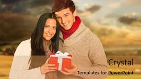  Presentation with gift - Amazing PPT theme having young couple holding a gift against country scene backdrop and a gold colored foreground