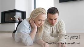  Presentation with internet surfing - Theme having young couple on the floor in front of fireplace surfing internet using digital tablet on cold winter day background and a light gray colored foreground
