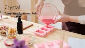  Presentation with molds - Presentation featuring young creative female pouring pink liquid soap mass from bowl into silicone molds while standing by workplace background and a coral colored foreground