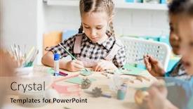  Presentation with classmates - Slide set featuring young creative girl sitting by desk among classmates and painting handmade paper christmas decoration before holiday background and a lemonade colored foreground