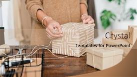  Presentation with christmas presents - Colorful presentation theme enhanced with young female binding wrapped giftbox with threads while preparing christmas presents by wooden table backdrop and a coral colored foreground