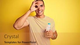  Presentation with plastic bottle - Beautiful slide set featuring young handsome man holding plastic water bottle over yellow isolated background with happy face smiling doing ok sign with hand on eye looking through fingers backdrop and a gold colored foreground