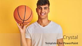  Presentation with basketball - Colorful presentation enhanced with young indian sportsman holding basketball ball standing over isolated yellow background with a happy face standing and smiling with a confident smile showing teeth backdrop and a yellow colored foreground