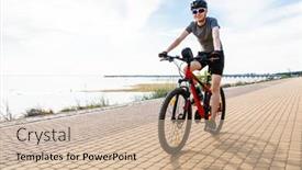  Presentation with biking - Amazing PPT theme having young man biking at seaside backdrop and a soft green colored foreground