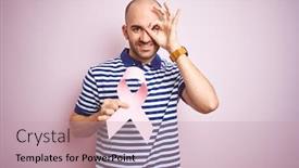  Presentation with pink ribbon - PPT theme with young man holding pink brest cancer ribbon over isolated background with happy face smiling doing ok sign with hand on eye looking through fingers background and a soft green colored foreground