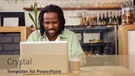  Presentation with cafeteria - Slide deck featuring young man sitting at table using laptop in cafeteria background and a coral colored foreground