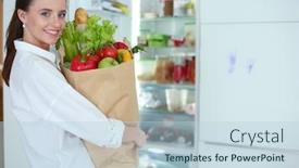  Presentation with grocery bag - Beautiful slide set featuring young woman holding grocery shopping bag with vegetables standing in the kitchen woman in the kitchen looking at the camera backdrop and a lemonade colored foreground