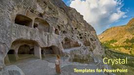  Presentation with cave - PPT theme having young woman in famous vardzia cave town monastery landmark of georgia background and a tawny brown colored foreground