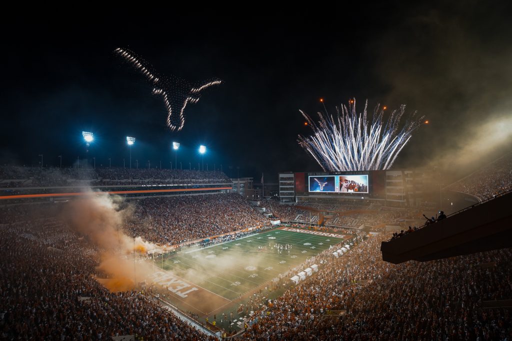 football field with lights and smoke