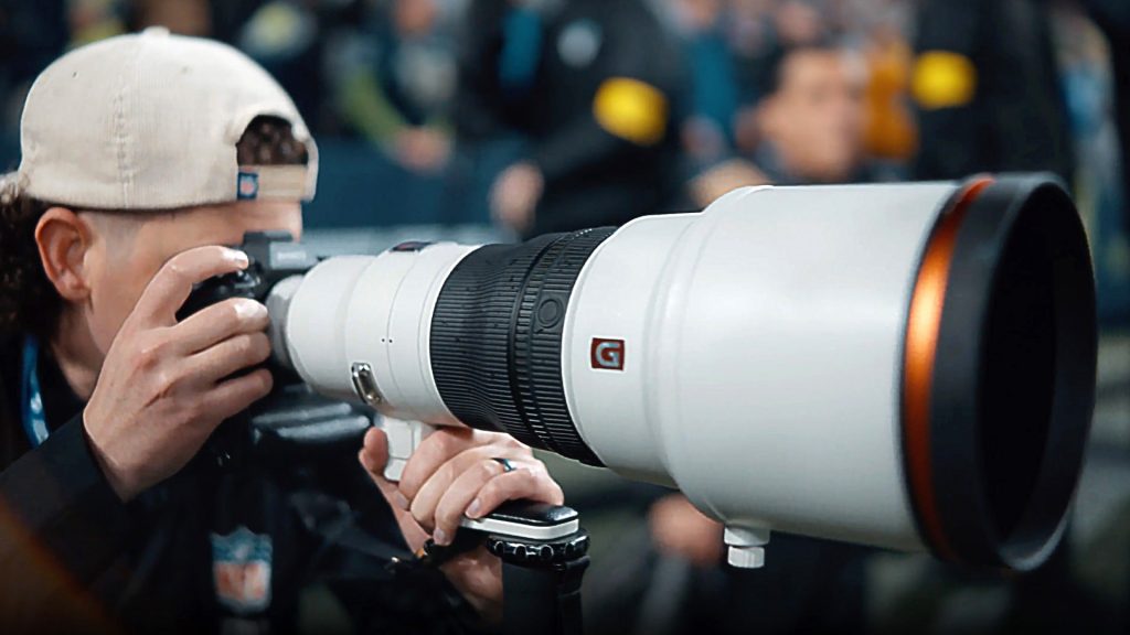 sports photographer with camera and lens