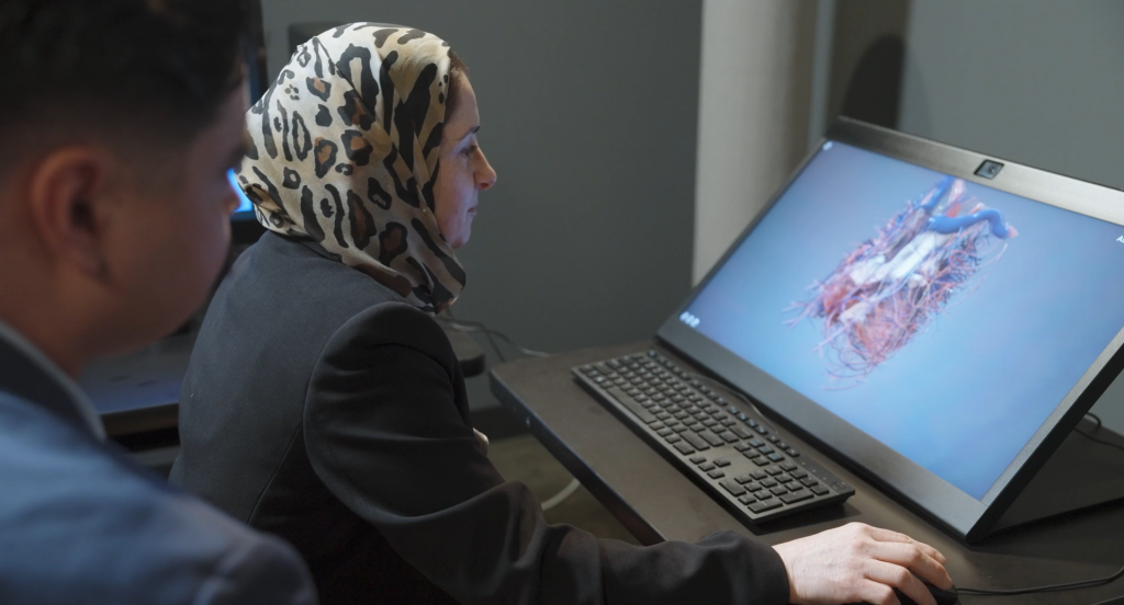 person using glasses free 3d display