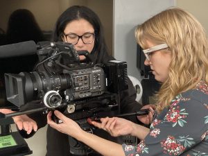 two students with camera