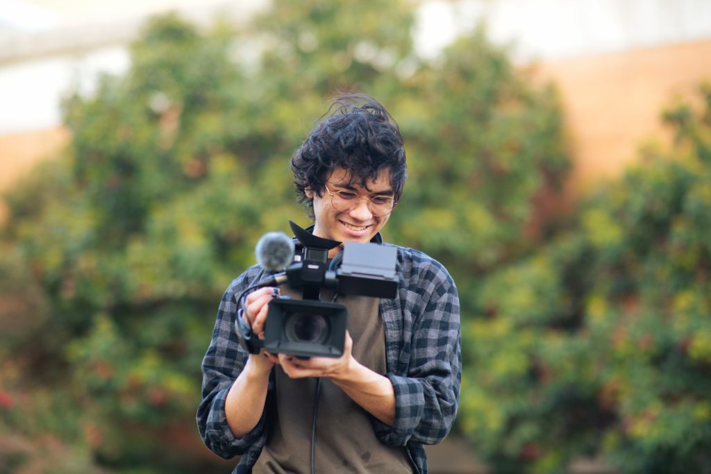 student holding camera