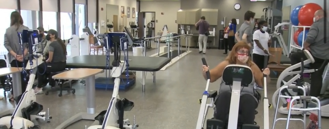 Various people at an indoor gym using different types of equipment
