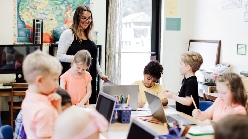 Educator supports students during structured literacy classroom instruction