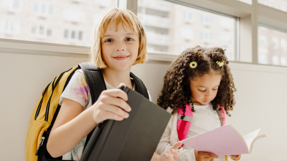 Two students reading books and building knowledge