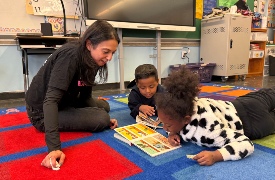 volunteer-with-two-students-WF2613250