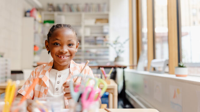 Child in a classroom working towards stronger literacy outcomes.
