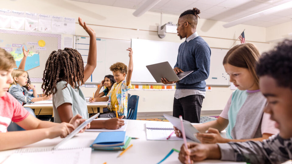 teacher leading students in a classroom discussion